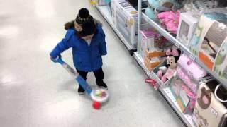 cute chinese baby playing with fisher price corn popper