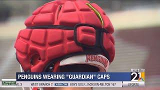 YSU football wearing guardian caps