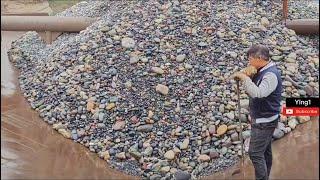 Barge unloading cobblestone.  smooth cobblestone flow