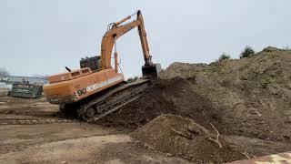 Excavator Climbing Dirt Pile