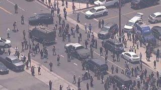 ICE agents confronted as tensions flare up following raids across Los Angeles