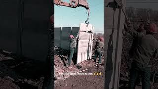 Precast concrete panels installing wall with useful excavator