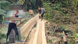 Cutting wood to make a roof for the barn,and his father and uncle laid the corrugated iron roof