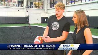 Tory Taylor teaches KCCI's Shannon Ehrhardt how to punt