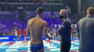 Olympic Swimmer Michael Andrew gives a swim fan his winning swim cap
