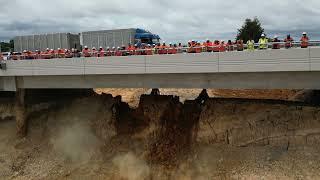 Digging under Cambridge Road bridge on Takitimu North Link