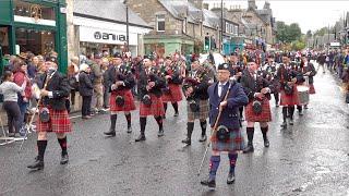 Kilsyth Thistle & Barrhead Pipe Bands in street parade marching to 2024 Pitlochry Highland Games