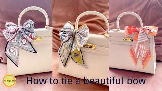 How to tie a beautiful bow on a bag with twilly .Accessorizing handbag handles with twilly.