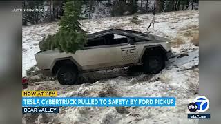 Tesla Cybertruck pulled to safety by Ford pickup after getting stuck in snowy embankment