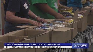 Volunteers lend helping hands at 15th annual holiday food box packing event