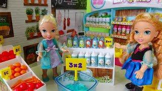 Elsa and Anna toddlers go shopping at the supermarket and buy toys