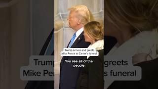 Trump arrives and greets Mike Pence at Carter's funeral