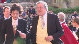 Stephen Fry arrives with husband Elliott Spencer for royal wedding