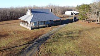 Rocking Chair Ranch.  Land for sale in Arkansas. Home with large porch on 80 acres.  Deer hunting.