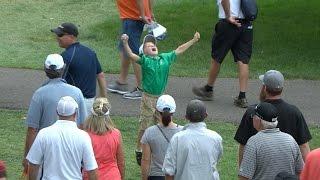 Kid celebrates Rory McIlroy giving him a golf ball at BMW