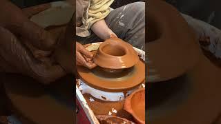 Person is trying to throw a vase on the pottery wheel and accidentally ruins it!