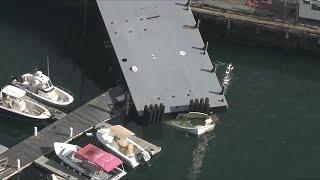 Crane collapses, sending barge crashing onto boat, pier