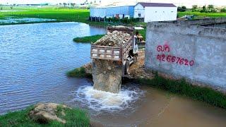 Start new project bulldozer push stone build the new road for fill land flood behind the wall