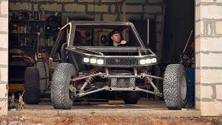 Wow! A man is building a unique all-terrain vehicle in a garage!