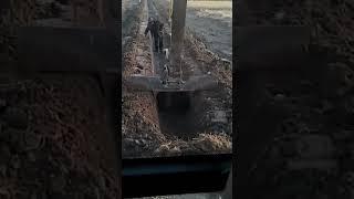 Creative bucket excavator making drainage ditch