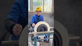 Beautiful machinist balancing a grinding wheel on a grinding machine