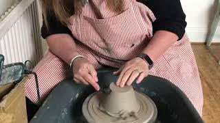 Trimming a pot on a pottery wheel