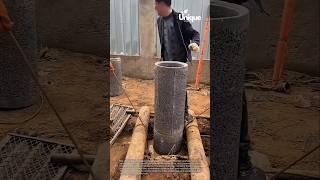 Construction workers stacking concrete well rings: well ring tutorial