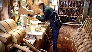 Process of making Acoustic guitar. Japanese guitar factory that plays classical music to the guitar