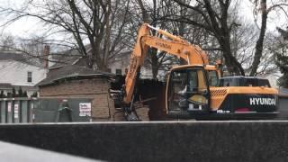 Excavator doing a Demolition of a Shed or garage or house Small but Sturdy