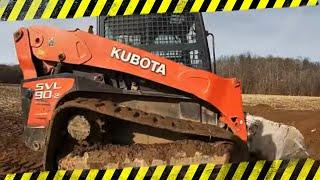 Kubota SVL 90-2 cleaning up debris from dirt perfects land clearing job