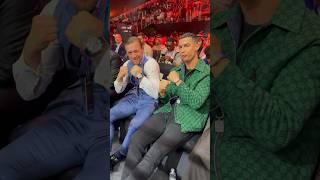 Cristiano Ronaldo and Conor McGregor sit next to each other ringside at the Day of Reckoning 