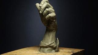 sculpting a hand in clay