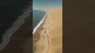 Drive along the beach where the ocean meets the Namib Desert in Namibia 