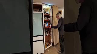 Lateral hinge on an angled front pantry