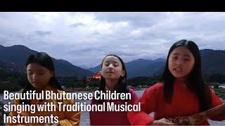 Beautiful Bhutanese Children singing with traditional musical instruments