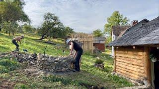 Construction of a stone fountain in a mountain village: preparing dinner for builders