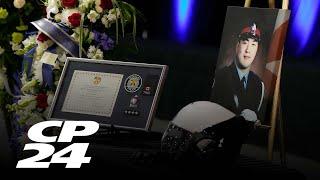 Family pay final respects to slain Toronto police officer