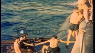 Rescued sailors are helped aboard a US Navy submarine near Okinawa, Japan. HD Stock Footage