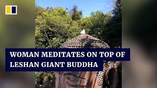 Woman meditates on top of Leshan Giant Buddha in China