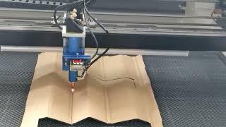 CO2 laser cutting machine cutting cardboard