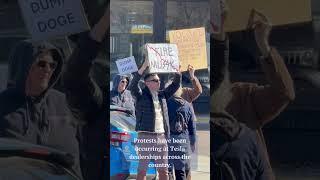 Protesters gather at Colorado Springs Tesla dealership