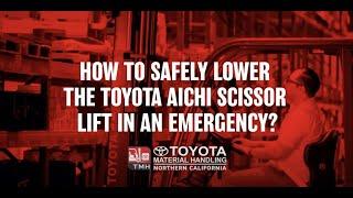 How to safely lower the Toyota Aichi Scissor Lift in an emergency?