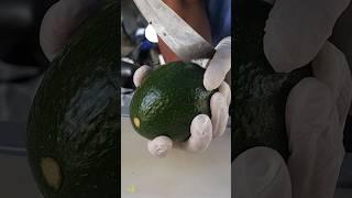 Street vendor cutting avocados uniformly