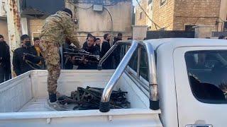 Former soldiers and police surrender weapons in Syria's Hama City