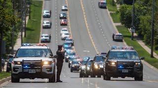 HONOURING A FALLEN OFFICER:  The casket of Const. Jeffrey Northrup escorted to funeral home