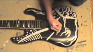 Emily Suzanne, painting a bass guitar