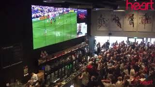 Fans in a bar cheering at soccer goal reaction meme/template