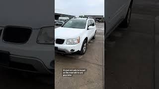 Totaled Dodge Grand Caravan with low miles and a rusted frame Pontiac Torrent at Auto Parts City