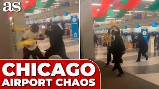 CHICAGO AIRPORT CHAOS: four men BRAWL using wet floor signs as WEAPONS