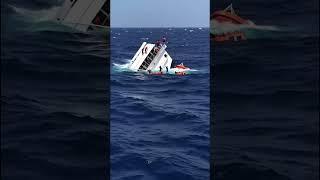 The ocean has nearly swallowed it whole—just the tip of the liner remains above the surface